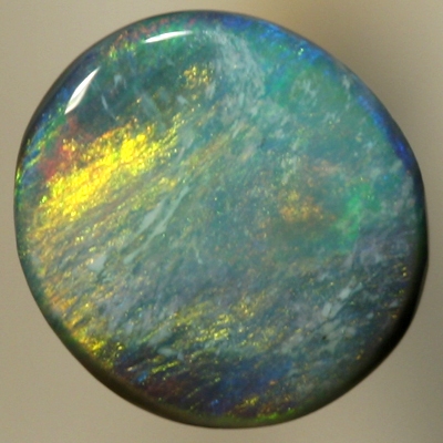 SOLID BLACK OPAL Golden fire of red and copper over a green - blue background